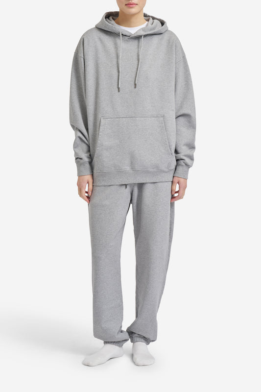 Unisex jersey hoodie and sweatpants set, pre-washed grey melange organic cotton, loose fit with kangaroo pocket.