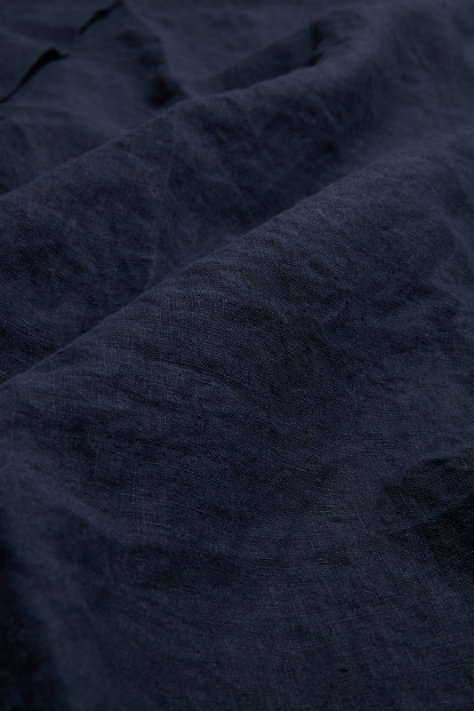 Unisex bathrobe, 100% Belgian linen, navy, with visible texture and soft folds.
