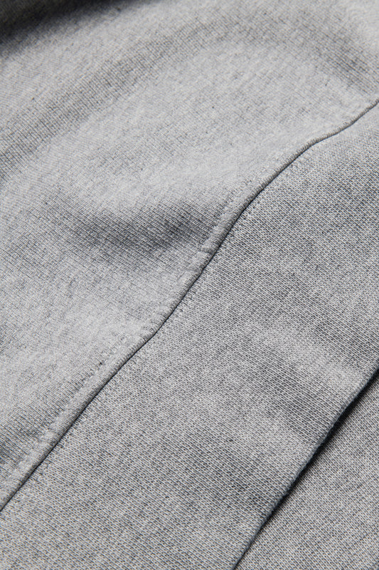 Men's knit sweater, organic cotton, pre-washed, grey melange, close-up of fabric and seam.
